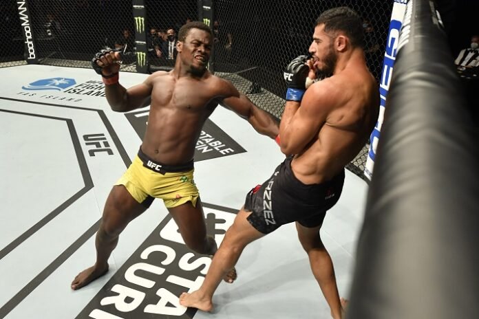 Abdul Razak Alhassan of Ghana punches Mounir Lazzez UFC Fight Island 1