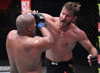 Stipe Miocic punches Daniel Cormier during the UFC 252 main event