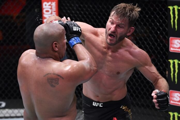 Stipe Miocic punches Daniel Cormier during the UFC 252 main event