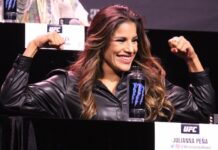 Julianna Pena flexes during the UFC 269 press conference