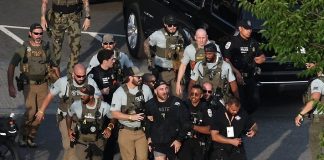 Sean Strickland being escorted from the Ellipse
