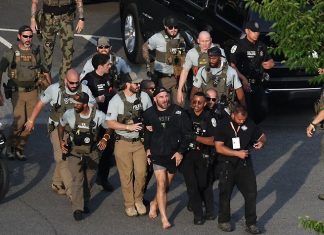 Sean Strickland being escorted from the Ellipse