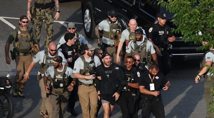 Sean Strickland being escorted from the Ellipse