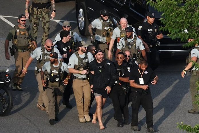 Sean Strickland being escorted from the Ellipse